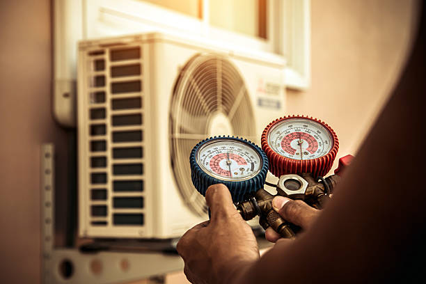 Professional Hvac technician working in Falkville, AL